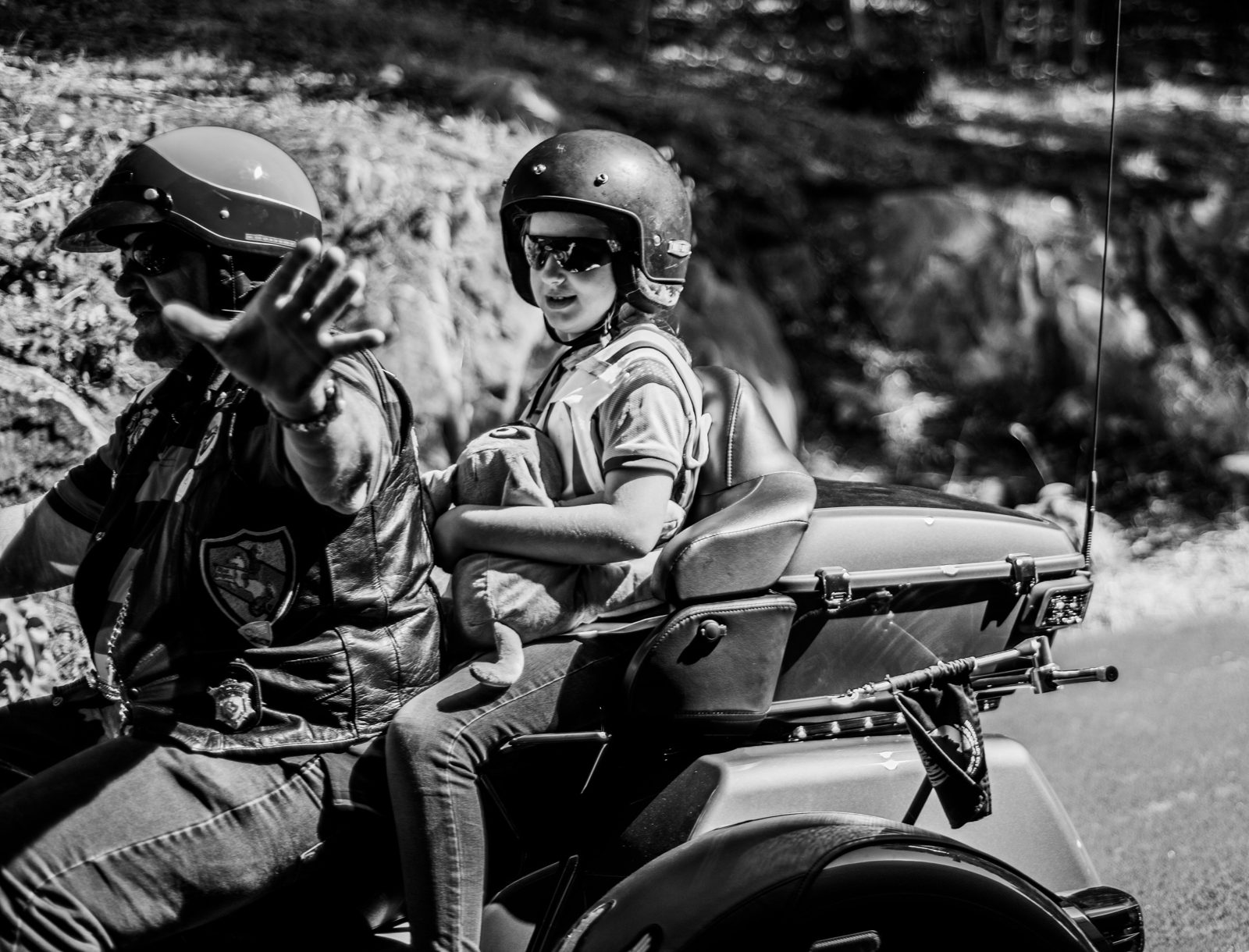 A rider waving during the motorcycle ride